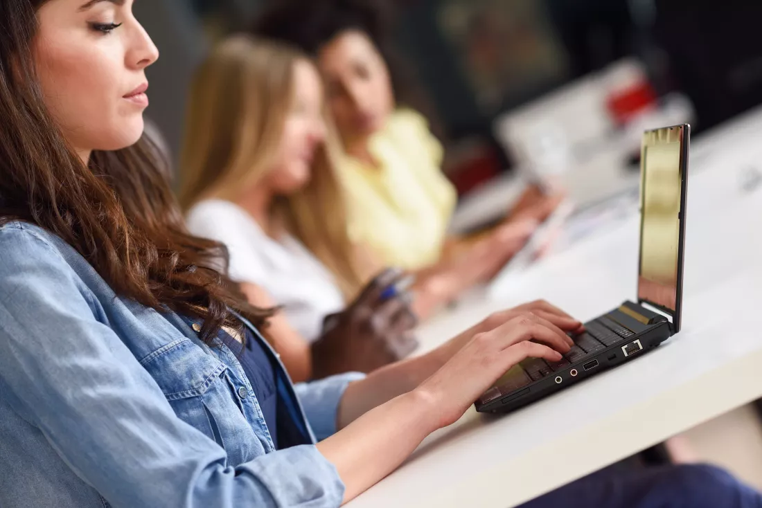 young-woman-studying-with-laptop-computer-white-desk