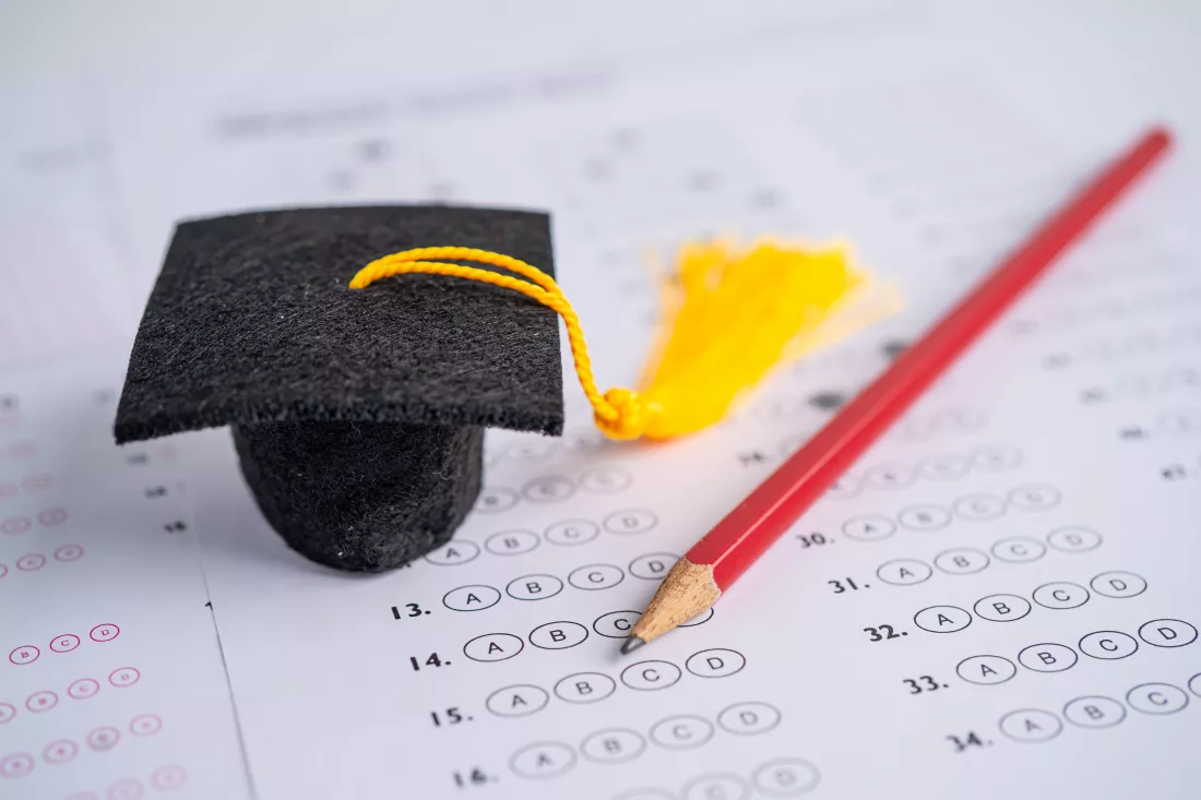 graduation-gap-hat-pencil-answer-sheet-background-education-study