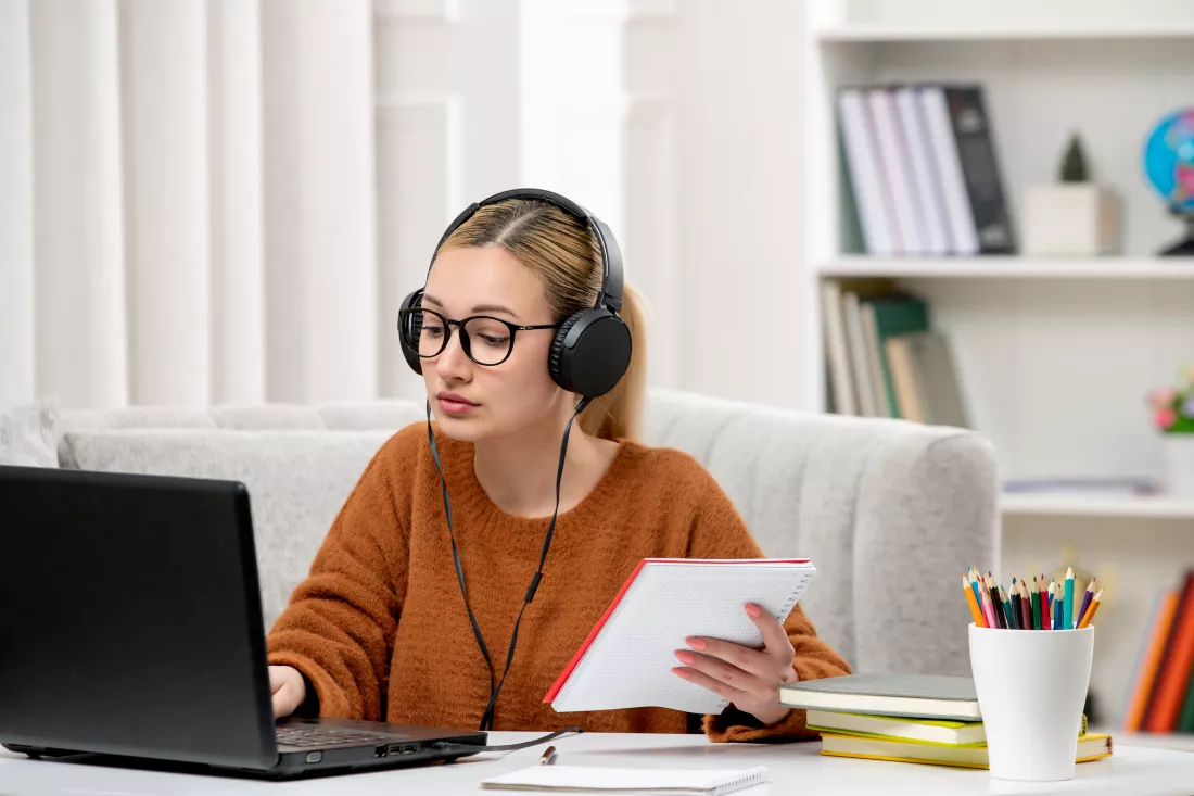 student-online-cute-girl-glasses-sweater-studying-computer-typing-keyboard