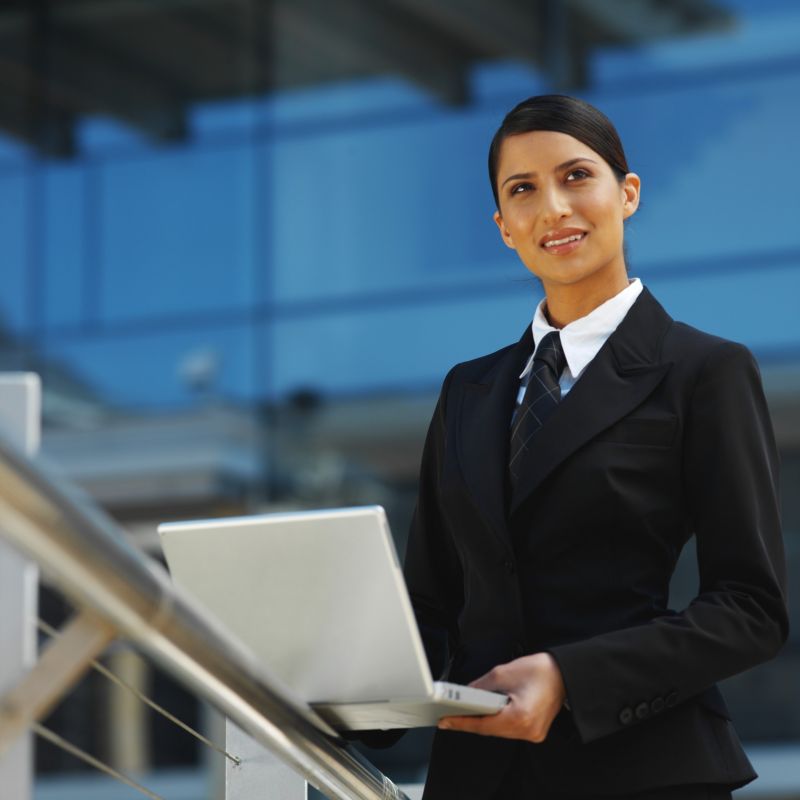 Front View Of A Businesswoman Using A Laptop - W1