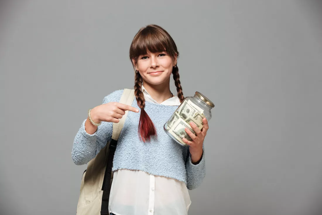 girl-standing-with-jar-full-money